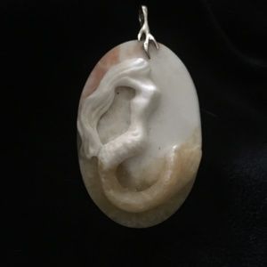 Carved Mermaid pendant on sterling silver Neptune's Trident bail.  A favorite.